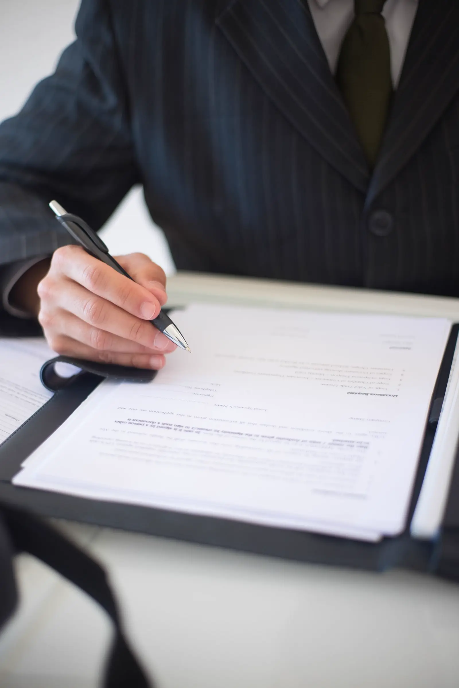 A pen resting on a contract ready for signature
